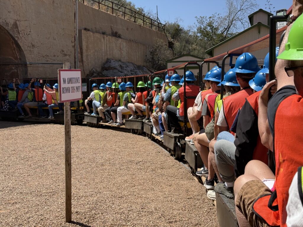 Arizona airstream rally participants wearing hardhats and riding a train to tour the Queen mine in Bisbee Arizona
