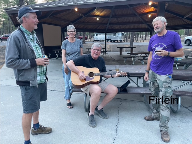 Airstream club members enjoying some guitar playing during happy hour at an Airstream Club rally in Arizona 
