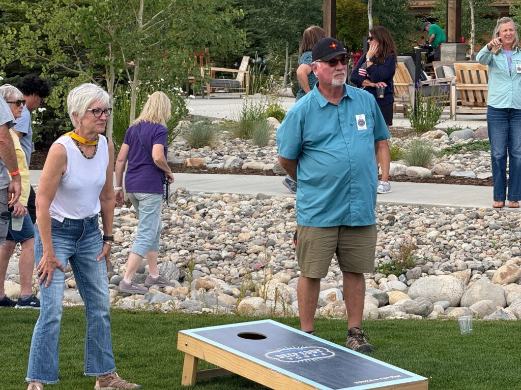 Airstream owners playing corn hole at Region 11 Airstream Club rally at Granby Colorado