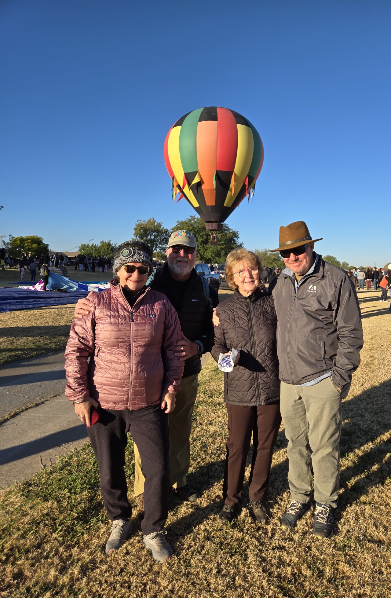 Airstream club members at a rally in Artesia, New Mexico, with hot air balloons