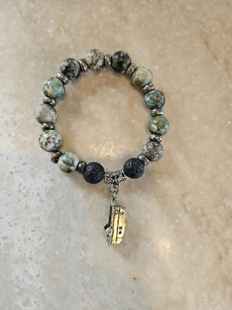 Charm bracelet with porous stones and Airstream charm at an Airstream Club rally in New Mexico