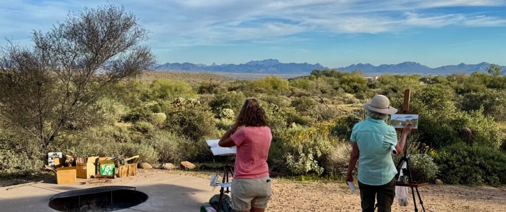 Airstream club members painting a Four Peaks scene during an Airstream Club rally in Arizona